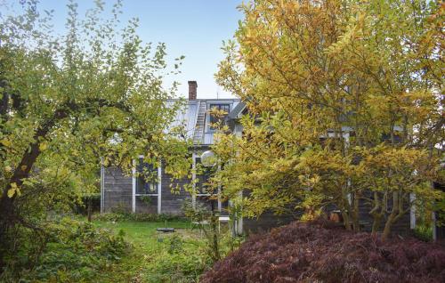 a house seen through the trees in the yard at Awesome Home In Vitaby With Wifi in Vitaby