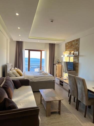 a hotel room with a bed and a couch at Milmari N69 in Kopaonik
