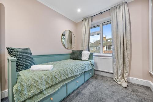 a bedroom with a bed and a window at Lovely Ealing 3 Bed Flat in Ealing