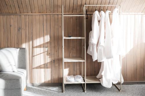 a room with a book shelf with white shoes at GORY & TYSHA Гори і Тиша in Yavoriv