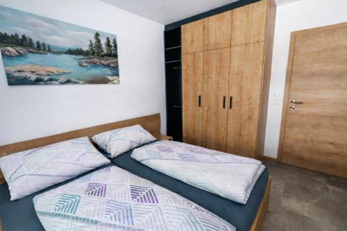 a bedroom with a bed and a wooden door at Danner Appartements Wolfsegg am Hausruck- Ferienwohnung & Business-Appartements Ruhige Lage, moderne Ausstattung, faire Preise in Wolfsegg am Hausruck