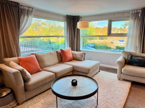 a living room with a couch and a table at FREE PARKING - Prime York City Centre Apartment near Minster with River View in York