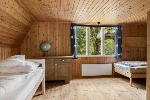 a bedroom with two beds and a window at HAL657-Knaered-Bjoerkered-72 in Körsveka