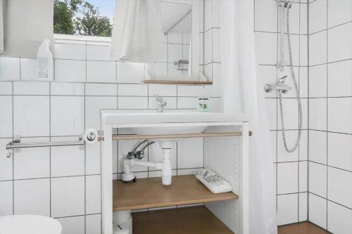 a white bathroom with a sink and a shower at HAL657-Knaered-Bjoerkered-72 in Körsveka