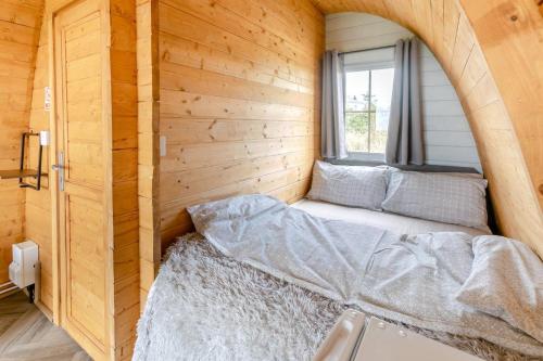 a small bed in a room with a window at 1 Bed in Four Lanes oc-b32769 in Carnbrea