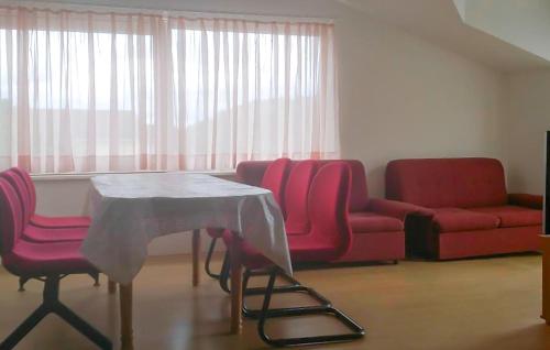 a living room with a table and chairs and a couch at 3 Bedroom Lovely Apartment In Rogotin-Ploce in Rogotin