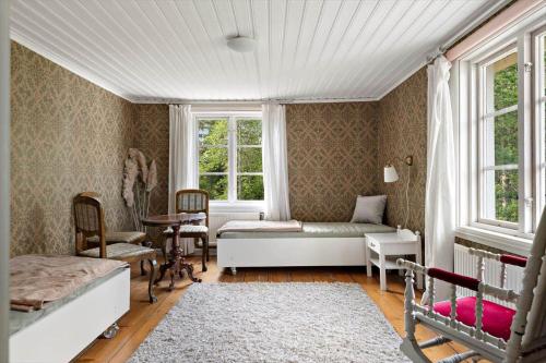 a bedroom with a bed and a table and a window at KAL558-Virserum-Holm-6 in Holm