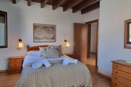 Un dormitorio con una cama grande con almohadas azules. en La Ayalga casa de campo, en Ardisana
