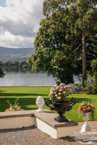 a vase filled with flowers sitting on top of a bench at Dromquinna Manor in Dunkerron Islands