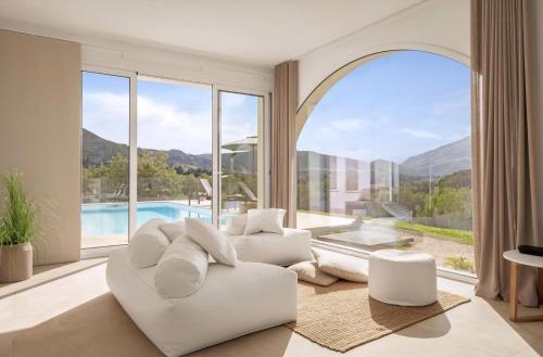 ein Wohnzimmer mit weißem Sofa und großem Fenster in der Unterkunft Historic Villa Overlooking Scopello Sea Stacks in Castellammare del Golfo