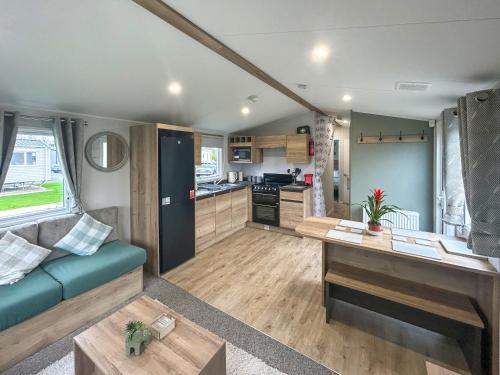een woonkamer met een bank en een keuken bij D & A Southview Getaway in Toynton All Saints