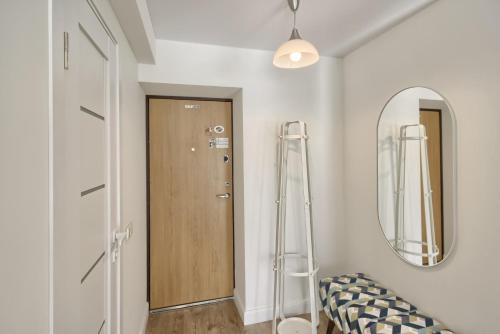 a hallway with a door and a mirror at Aqua apartment in Druskininkai