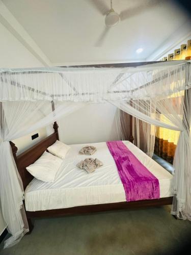 Postel nebo postele na pokoji v ubytování Lyra Mirissa