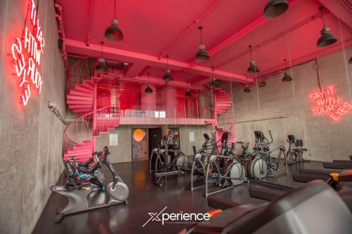 a gym with a bunch of bikes in a room at Teal at 12, City Views and Wonderland Vibes! in Hatillo