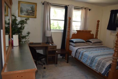 a bedroom with a bed and a desk and a desk at Miami Drip Star Life Resort in Parkway Regional Medical Center Heliport