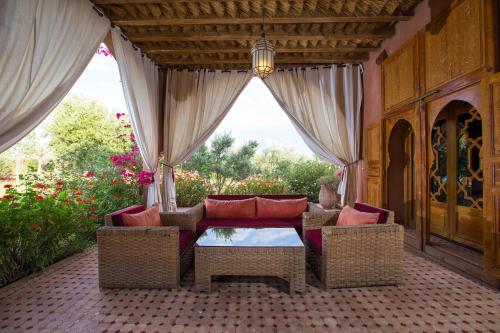 a patio with a couch and chairs and a table at Ksar Salha in Marrakech
