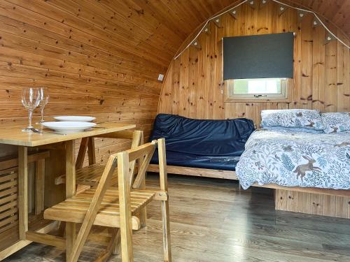a room with a bed and a table and a table and chairs at Meadow - Uk48483 in Dalton in Furness