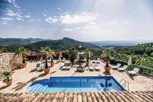 Ein Swimmingpool auf dem Dach eines Hauses mit Stühlen und Bäumen in der Unterkunft Posada del Marqués I A Slow Design Hotel in Esporles