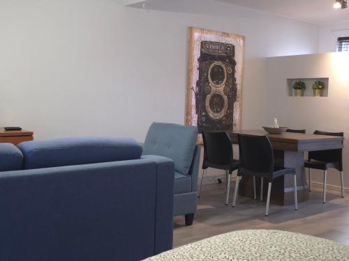 a living room with a blue couch and a table at STUDIO SAINT-ROCH in Quebec City