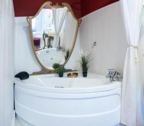 a bathroom with a mirror and a sink at Visconti apartment and Spa in Catania
