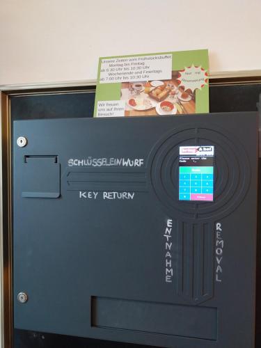 a television with a key retrieval screen on top of it at Gästehaus Langhammer in Bubenreuth