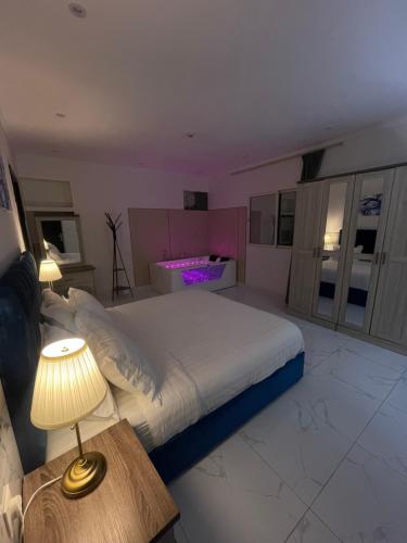 a bedroom with a large bed and a table with a lamp at شقة بنظام فيلا مستقلة بالكورنيش apartment with villa system in Jeddah