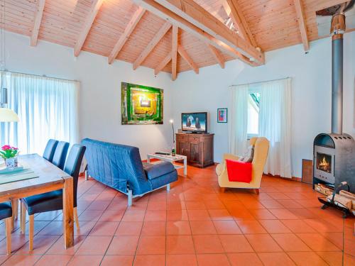 a living room with a table and chairs and a stove at Ferienhaus Lenz am Plauer See in Lenz