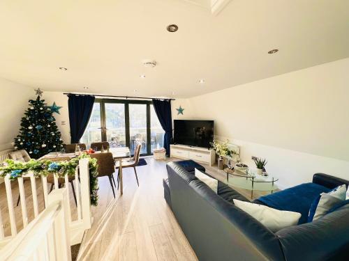 a living room with a christmas tree and a couch at The Barbican Penthouse in Plymouth