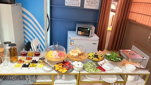a table with many different types of food on it at Baiterek Сарайшык 40 in Astana