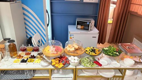 a table with many plates of food on it at Baiterek Сарайшык 40 in Astana