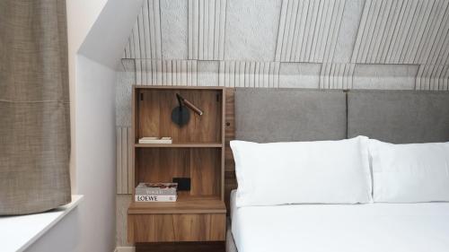 a bedroom with a white bed and a book shelf at Be Mate Citylife in Milan