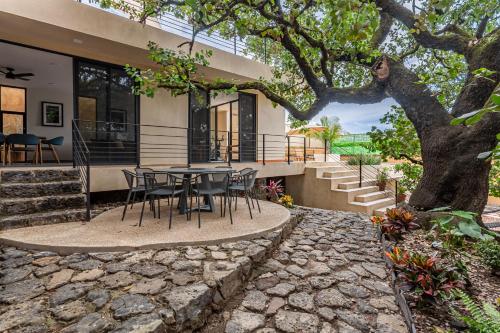 a table and chairs in front of a house at Casa Encino - Oasis to share in Tepoztlán
