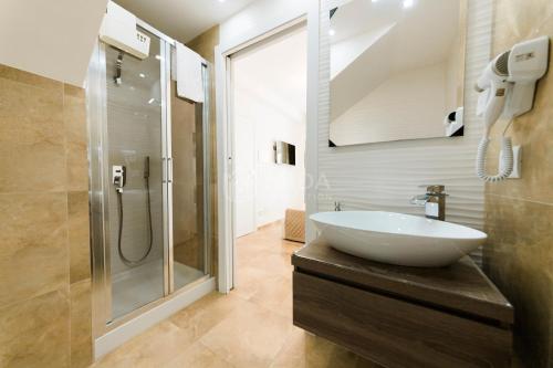 a bathroom with a sink and a shower at Artemar in Porto Cesareo