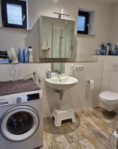 a bathroom with a washing machine and a sink at Ferienhaus Rhönblick in Bischofsheim an der Rhön