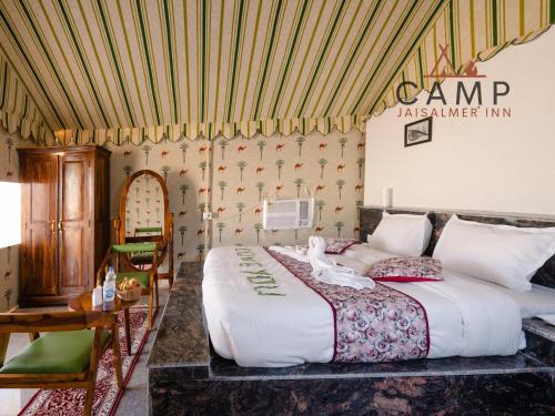 a bedroom with a large bed in a room at Camp Inn Jaisalmer Resort in Jaisalmer