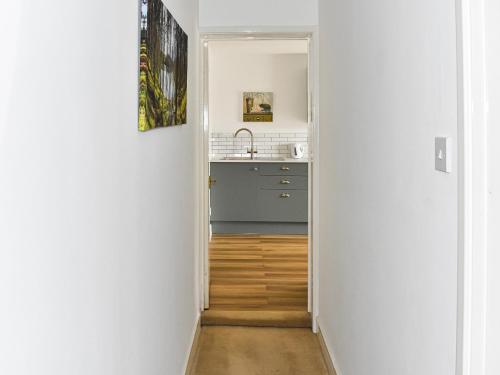 a hallway leading into a kitchen with a sink at Little Fishes in Ryde