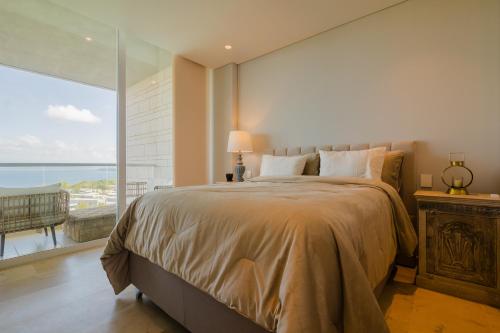 a bedroom with a large bed and a large window at Modern apt with 2 BR BBQ and views in Pendales