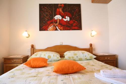 a bedroom with two orange pillows on a bed at Bonacic Palace in Slatine