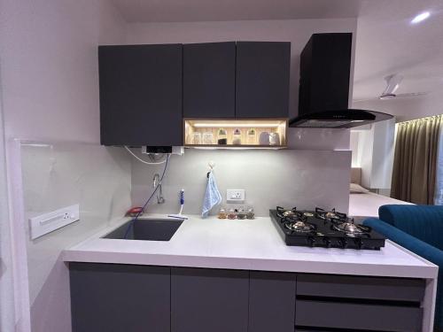 a kitchen with a sink and a stove top oven at The Tira luxe in Pune