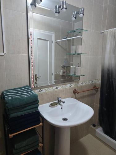 a bathroom with a white sink and a mirror at Villa Maritxu in Cangas de Morrazo