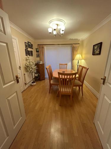 a dining room with a table and chairs at Balrath Wood - entire 3 bedroom house with drive and garden sleeps 5 in Kells