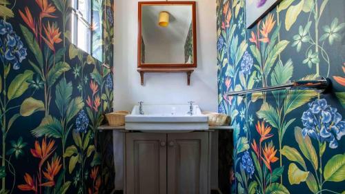 a bathroom with a sink and a mirror at Mountain view villa heated pool Nyeri - 2352 in Kuhora Twana