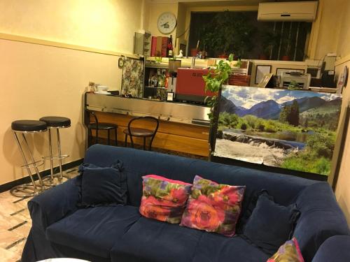 a blue couch with pillows in a living room at Hotel Bolognese in Foligno