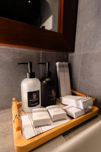 a shelf with two bottles of soap and a soap dispenser at RV Regency 19 Hotel in Tangalle