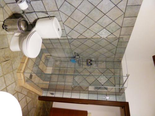 a bathroom with a toilet paper dispenser on a tiled wall at Anastasia Luxury Villas in Gavrio