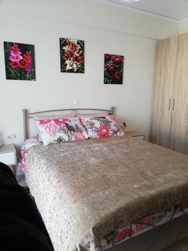 a bedroom with a bed with two pictures on the wall at Studio B1 in Mytilene