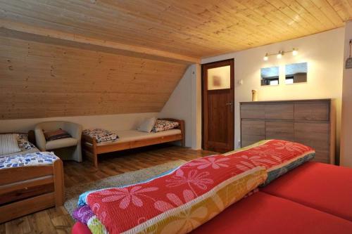 a bedroom with a bed and a bench in a room at Sauna Chata BedRich in Bedřichov