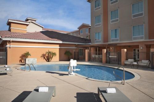 a swimming pool in front of a building at Homewood Suites by Hilton Yuma in Yuma