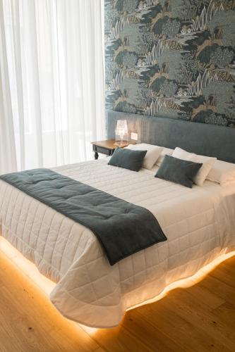 a bedroom with a large white bed with pillows at Casa Tanina in Bitonto