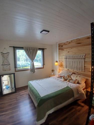 a bedroom with a large bed with a wooden wall at TerraNostra in Mar de Cobo